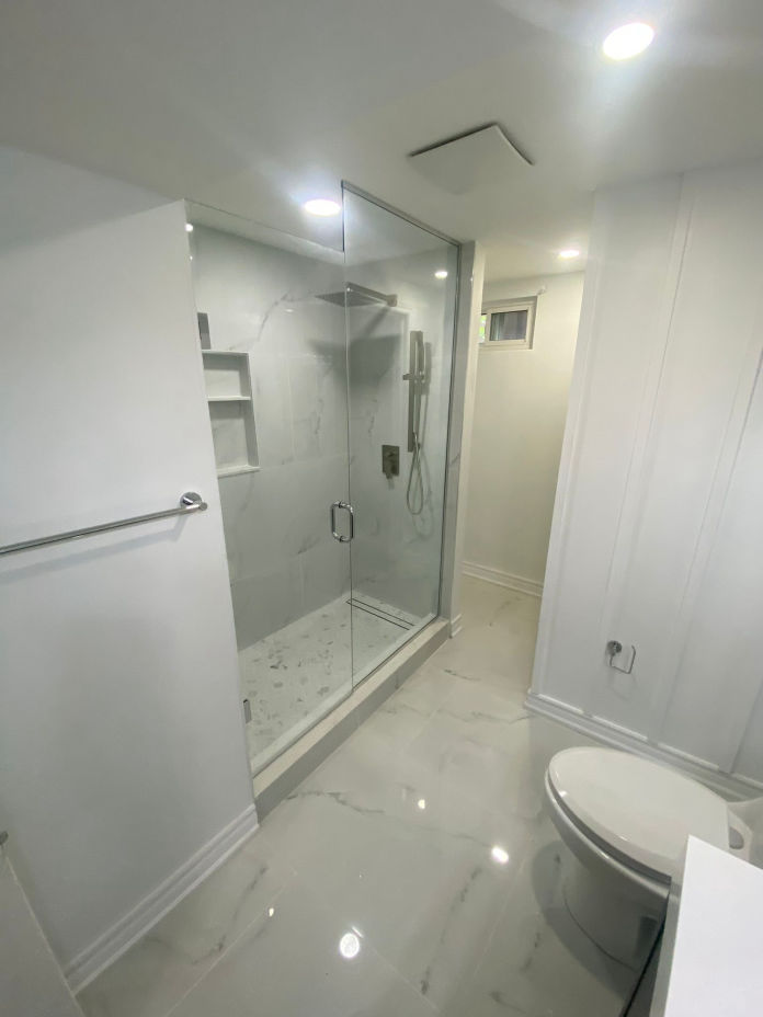 Complete bathroom renovation with new fixtures and lighting in NYC